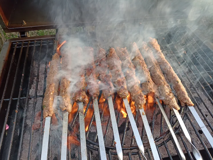 Seekh kababs grilling over open coals